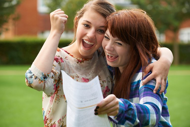 women smiling and celebrating