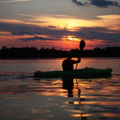 man boating on sunset